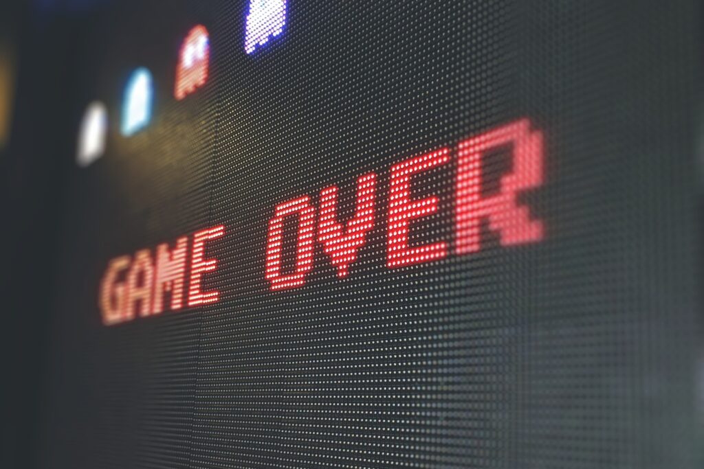 Pixelated Game Over screen on an oversized PAC-MAN arcade machine